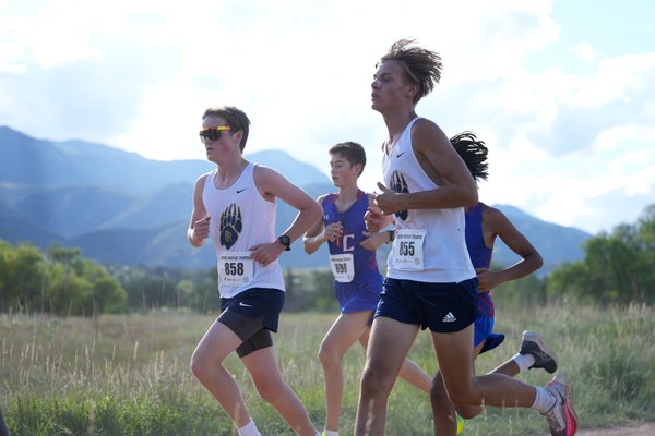 Palmer Ridge runners competing on a mountain cross country course